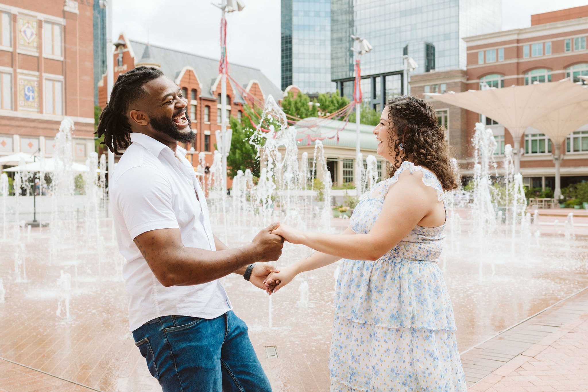 Engaged couple dancing in Sundance Square, downtown Fort Worth Engagement session, Sundance Square engagement session, Swan Photography